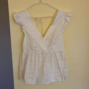 White eyelet peplum sleeveless blouse